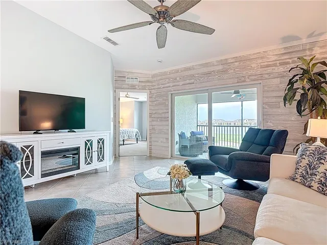 Living area featuring wood walls and tile patterned floors