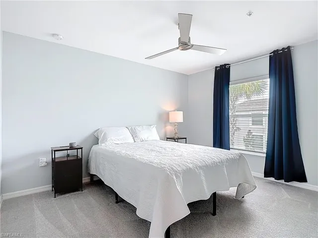 Bedroom featuring light colored carpet and a ceiling fan