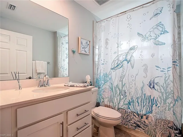 Full bath featuring vanity and shower / bathtub combination with curtain