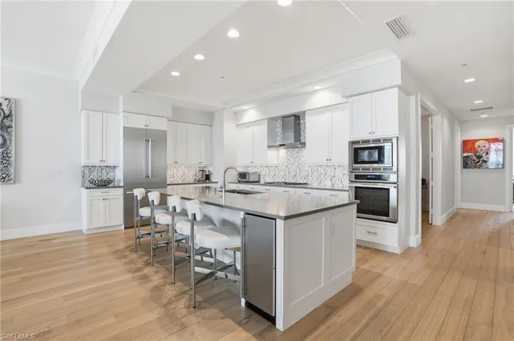 Stainless steel appliances, a stand alone ice maker,  custom backsplash, and ample counter space are just a few of this kitchen's highlights.