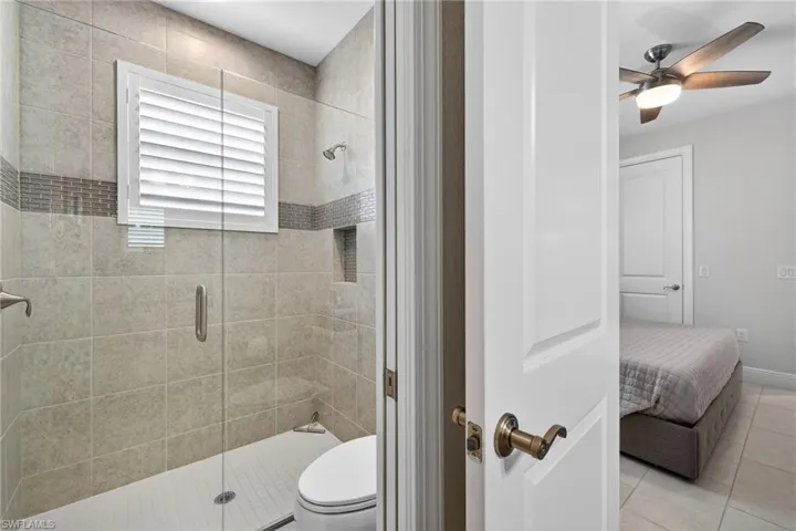 Ensuite bathroom featuring large vanity and a luxury shower stall
