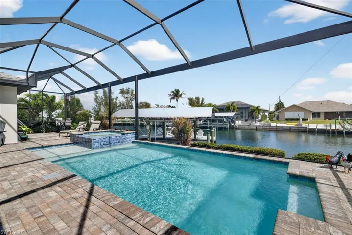 Relaxing pool / spa featuring a water view