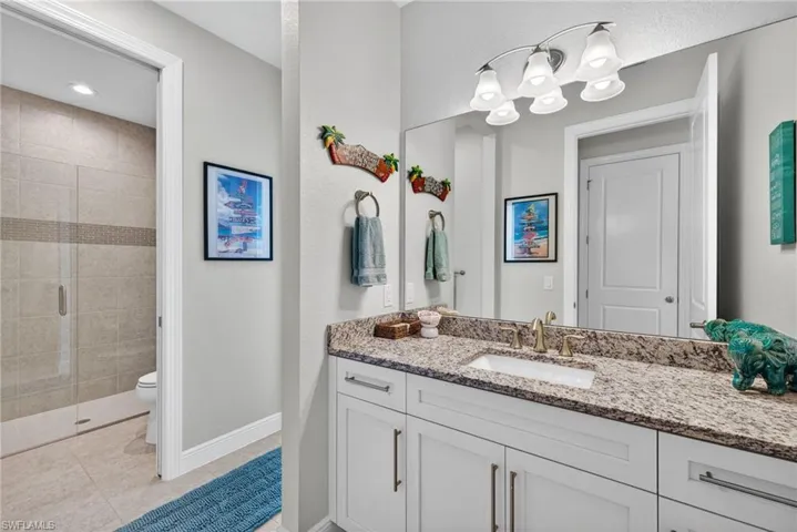 Full size pool bath with glass entry door and luxury shower.