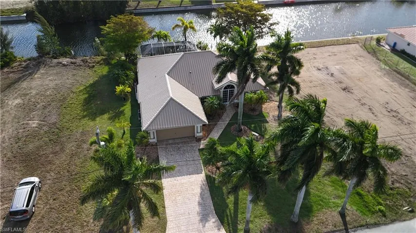 Aerial view of property and surrounding area featuring a large body of water