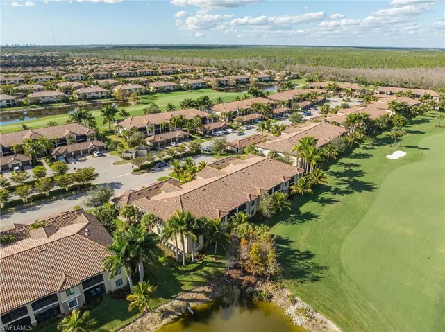 Aerial perspective of suburban area with a large body of water and a local golf course