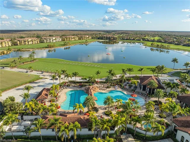 Drone / aerial view of a large body of water and a local golf course