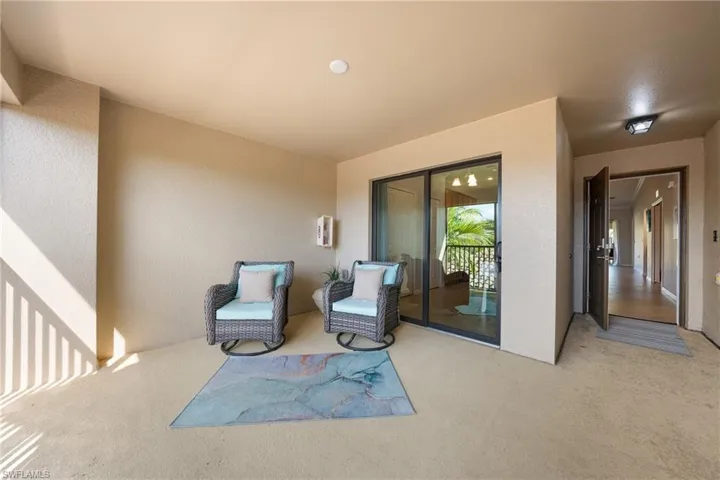 Sitting room featuring a textured wall and carpet flooring