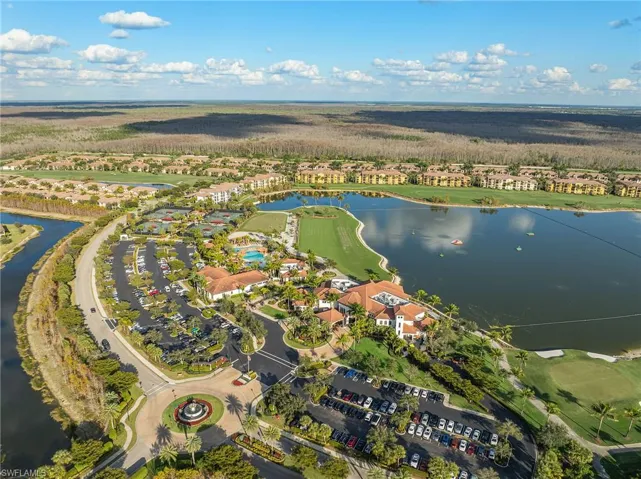 Aerial perspective of suburban area with a nearby body of water and a golf club