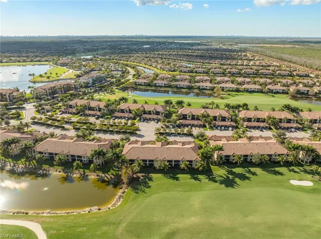Aerial perspective of suburban area featuring a nearby body of water