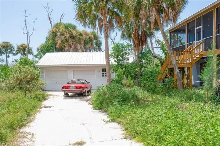 View of home's exterior featuring a sunroom and a garage