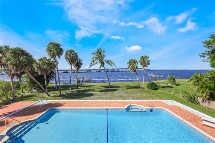 View of swimming pool featuring a yard and a river view