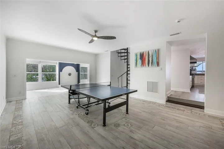 Recreation room with ceiling fan and light hardwood / wood-style flooring