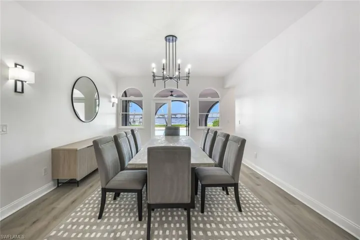Dining area with hardwood / wood-style floors and a chandelier