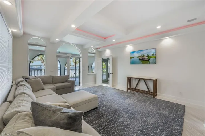 Living room with beam ceiling and hardwood / wood-style floors