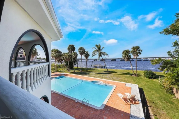 View of pool featuring a river view, a patio area, and a yard