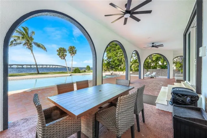 View of terrace with a water view and ceiling fan