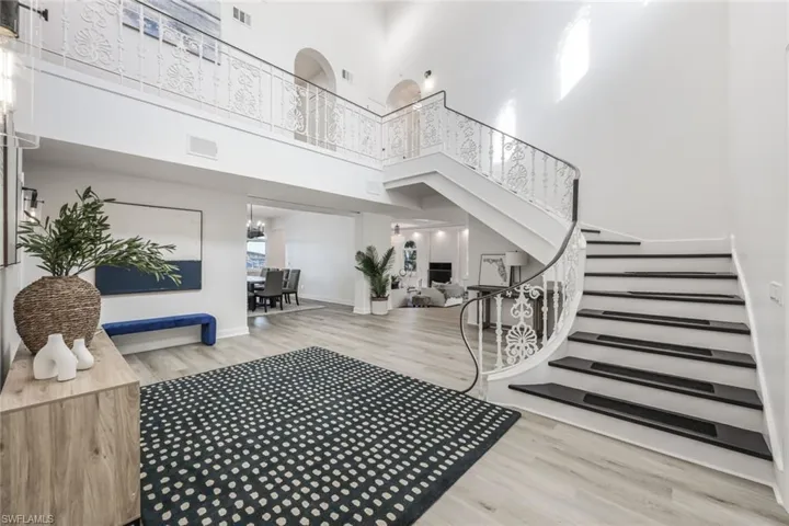 Foyer featuring a high ceiling and light hardwood / wood-style flooring