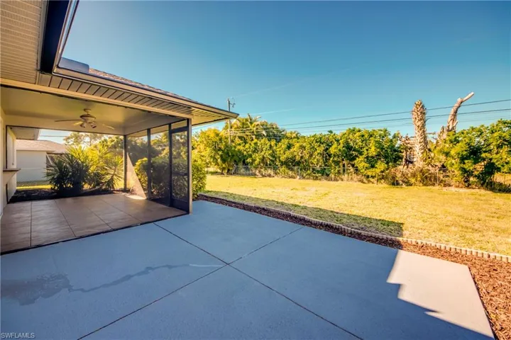 View of patio / terrace featuring a sunroom and ceiling fan