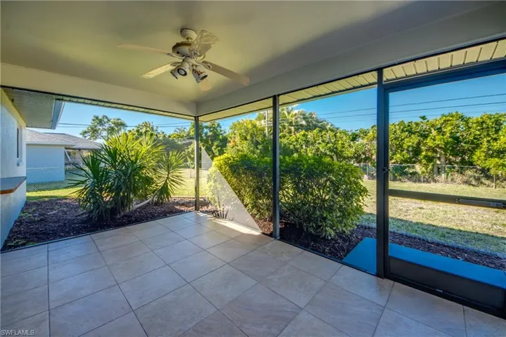 Unfurnished sunroom featuring ceiling fan