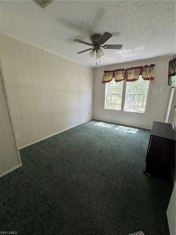 2nd Bedroom, Carpeted room with ceiling fan, a textured ceiling, and crown molding