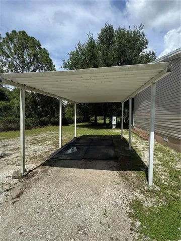 View of parking / parking lot with a carport