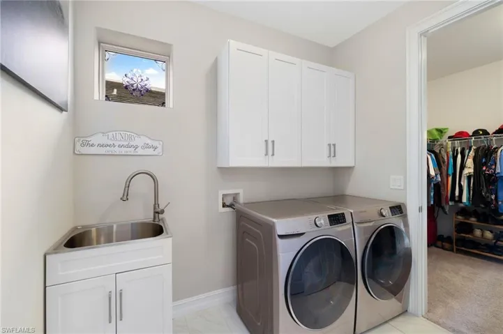Laundry Showing Door Open to Primary Bedroom Walk-In Closet