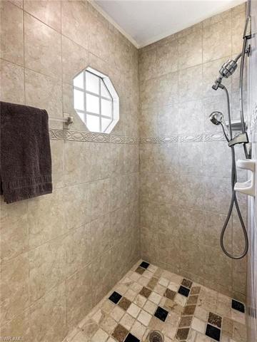 STEP-IN TILED SHOWER IN PRIMARY BEDROOM