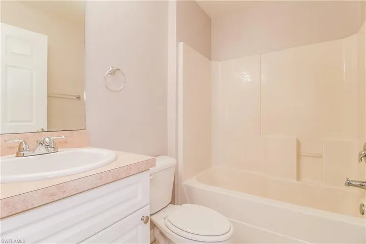 Bathroom featuring vanity and washtub / shower combination