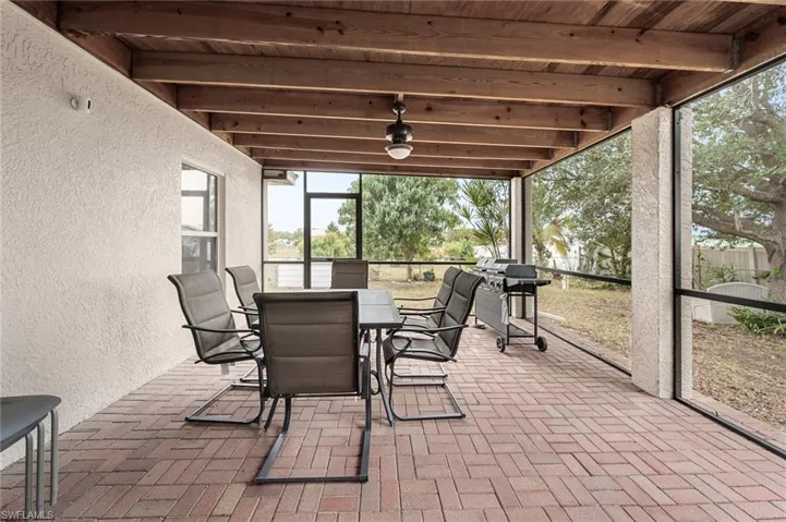 Sunroom featuring wood ceiling and beamed ceiling
