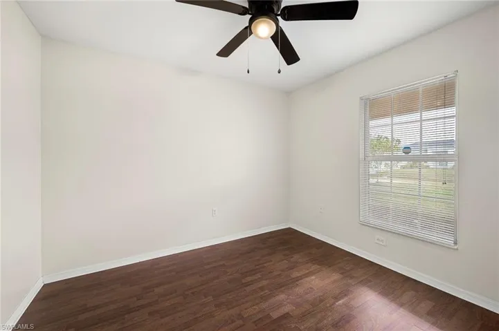 Unfurnished room featuring dark wood-type flooring