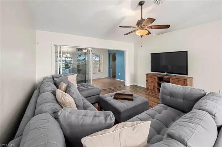 Living room featuring ceiling fan and hardwood / wood-style flooring