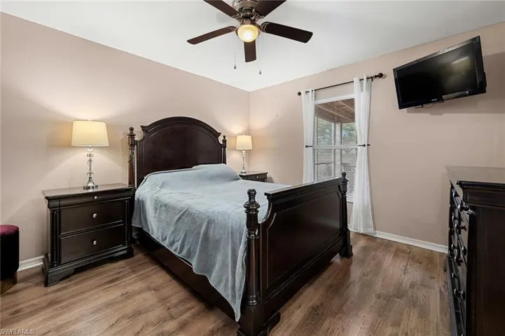 Bedroom featuring ceiling fan and hardwood / wood-style floors
