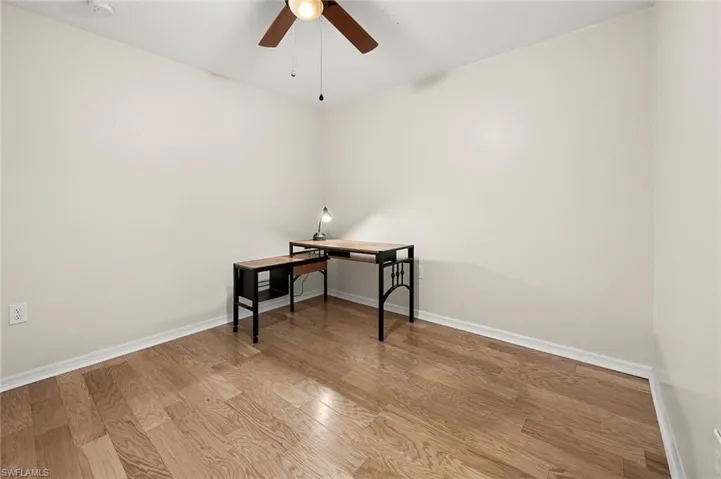 Office space featuring ceiling fan and light hardwood / wood-style floors