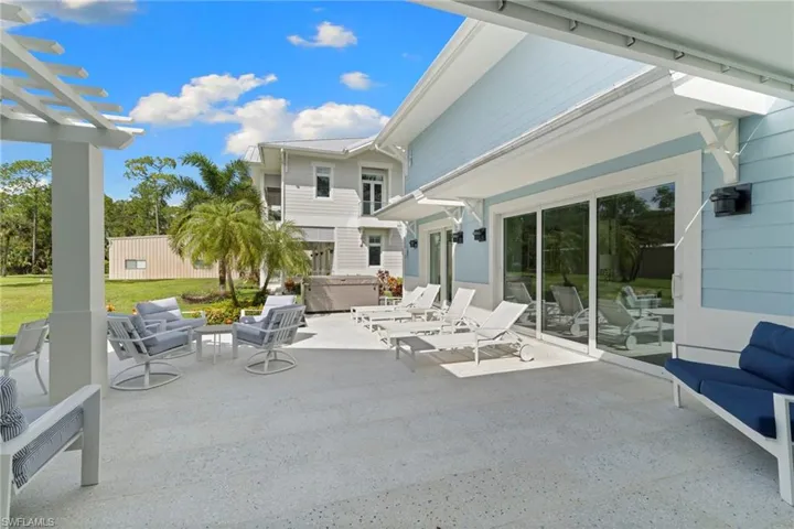 View of home's exterior featuring a metal roof, decorative driveway, a standing seam roof, an attached garage, and a lawn