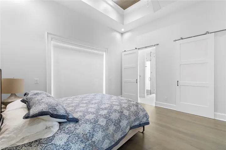 Bathroom featuring double vanity, a shower stall, and light tile patterned floors