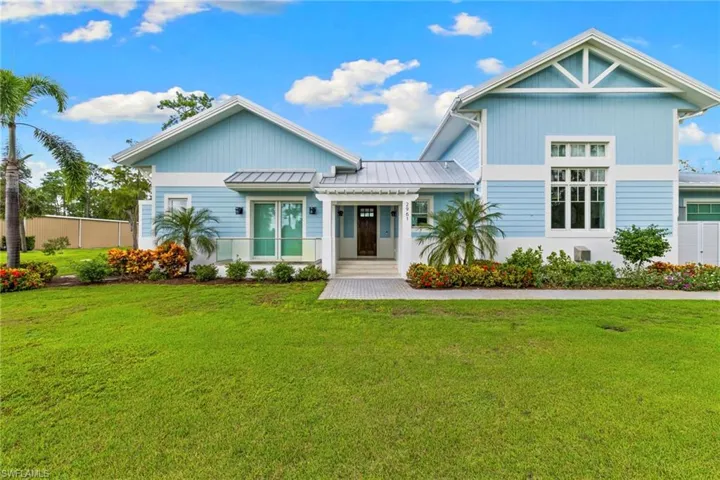 View of front of house featuring a standing seam roof and a metal roof