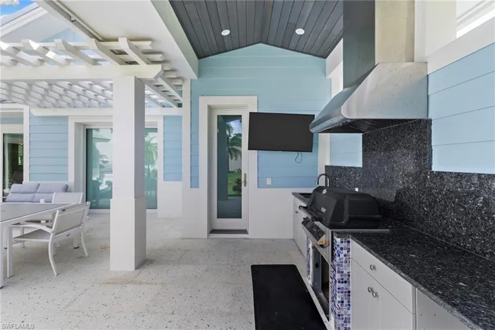 View of patio / terrace with a hot tub, an outdoor hangout area, and a pergola