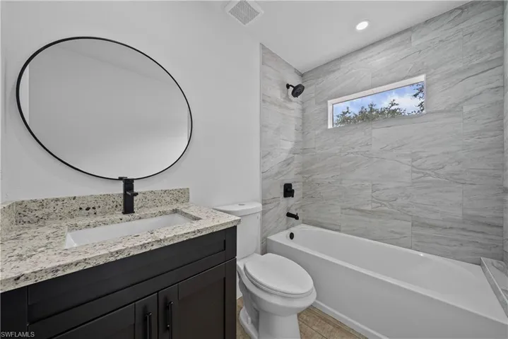 Full bath featuring vanity, shower / washtub combination, and recessed lighting