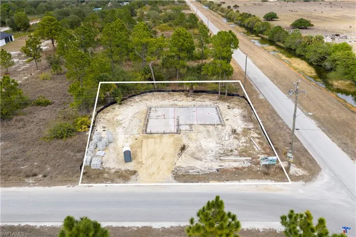 Aerial overview of property's location featuring property parcel outlined and a tree filled landscape