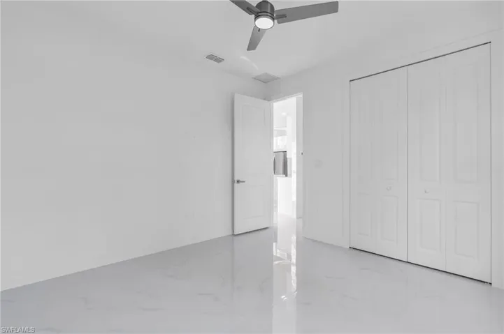 Unfurnished bedroom featuring ceiling fan and a closet