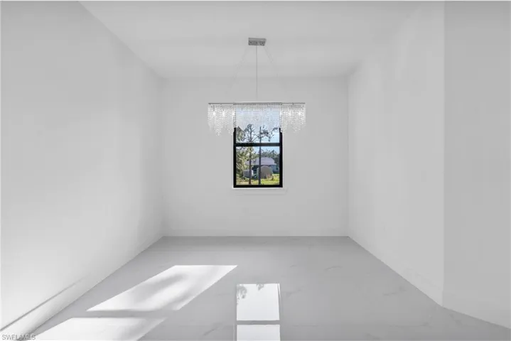 Unfurnished dining area with an inviting chandelier