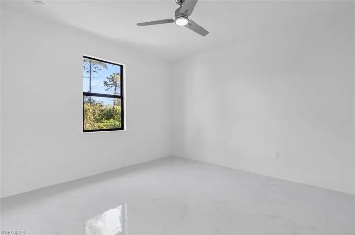 Unfurnished room featuring ceiling fan