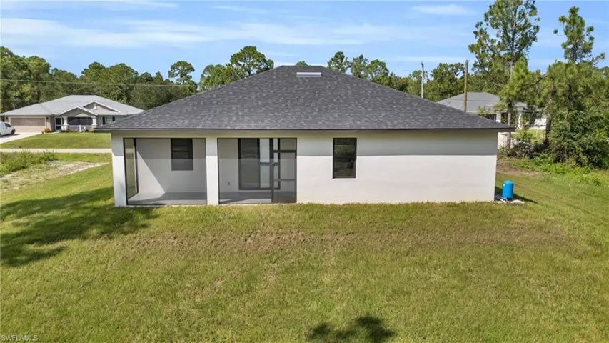 Rear view of property featuring a yard