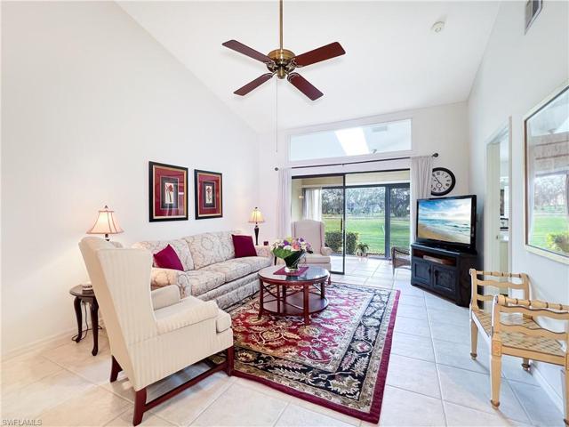 Living room looking to sunroom and water with golf course