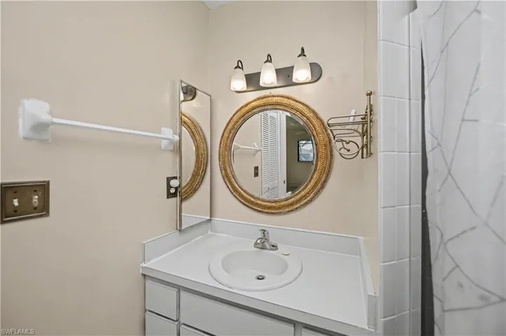 Full bath with vanity and a shower with shower curtain