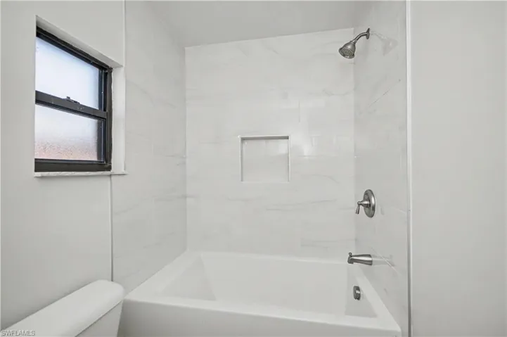 Full bathroom with shower / washtub combination and toilet