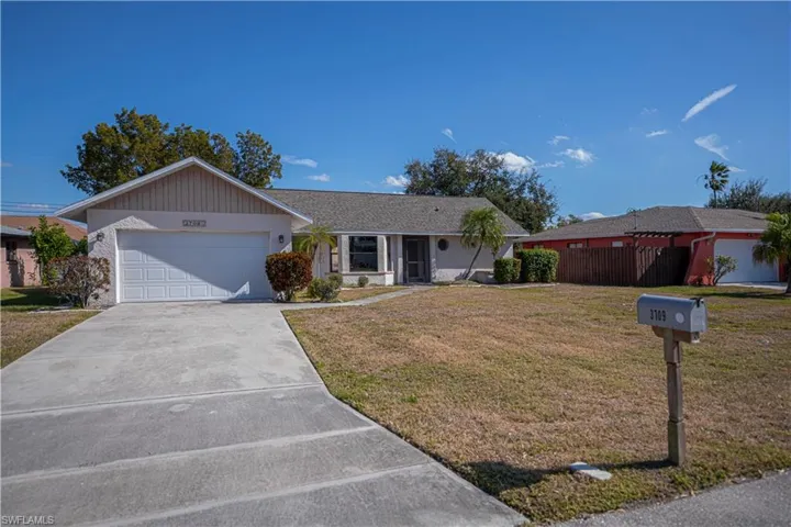 Ranch-style house featuring driveway and a garage