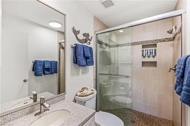 Bathroom with vanity and a stall shower