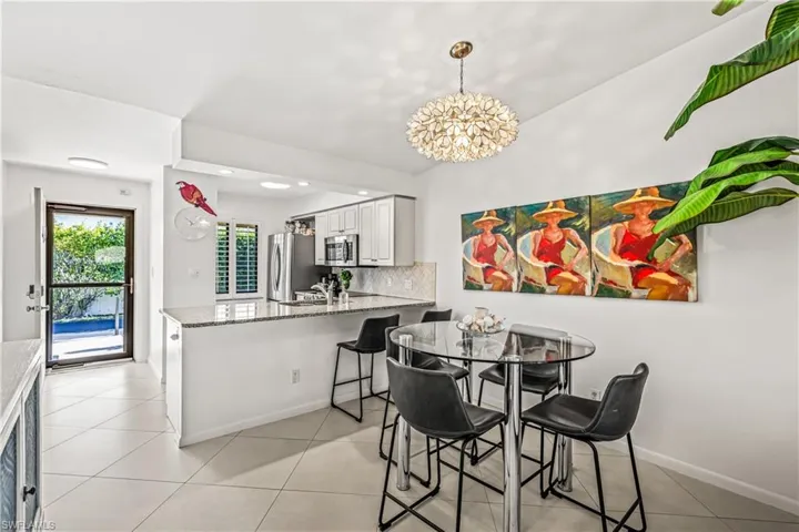 Dining room featuring light tile patterned flooring and hanging lights