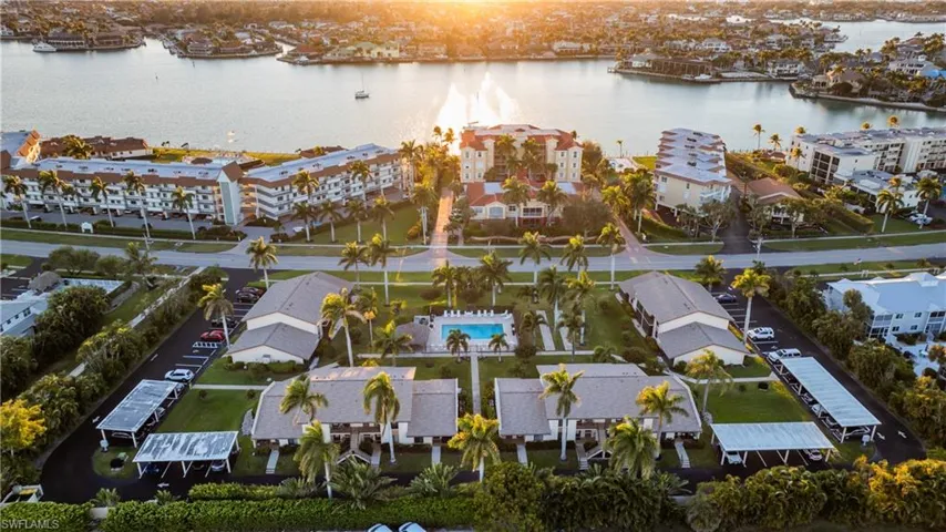 Aerial view of a nearby body of water and apartment complex / building